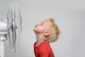 Hot-inside-the-house-boy-with-fan-SSHAC-June-Blog